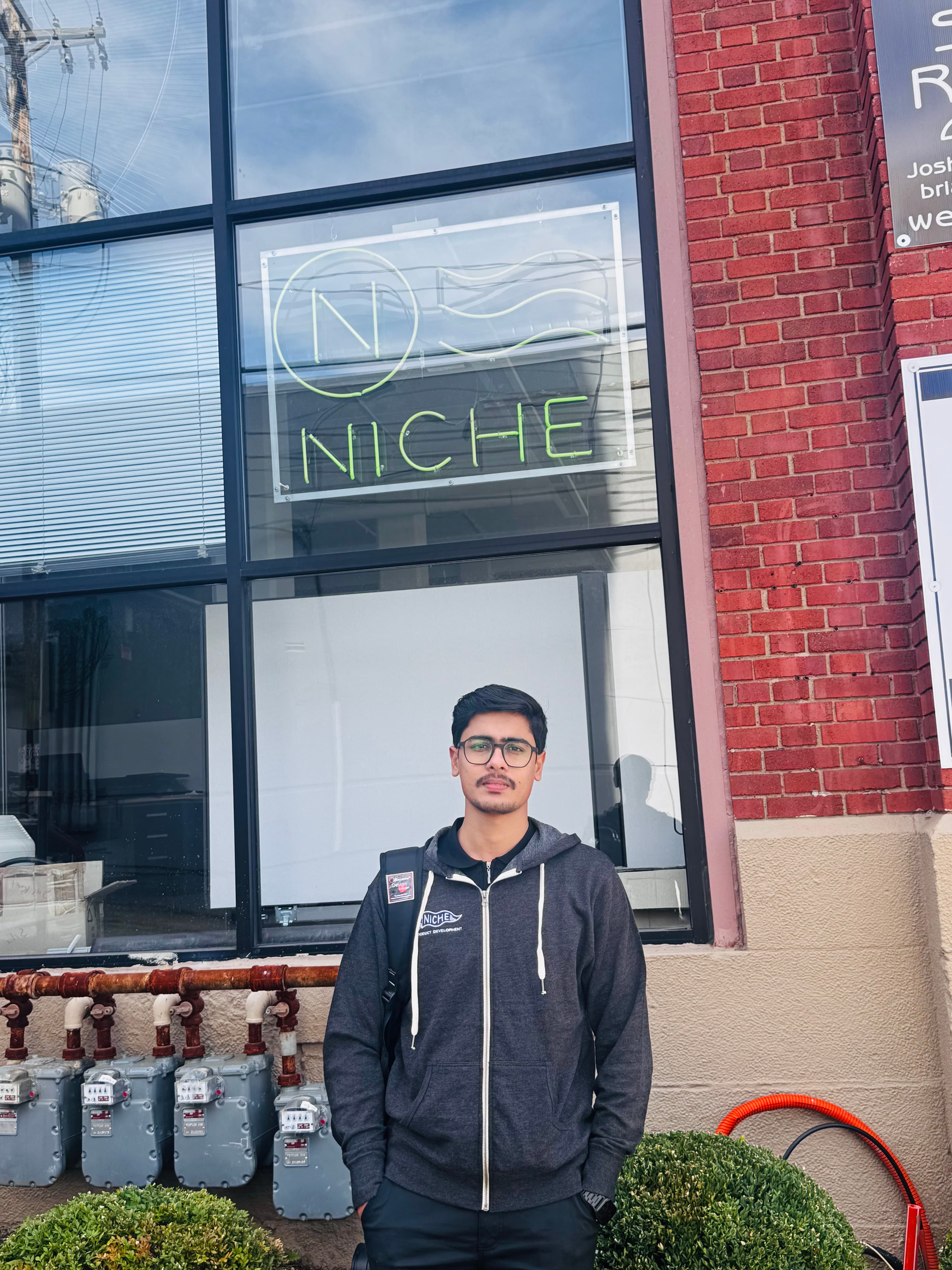 Syed Uzair Ali outside the Niche office