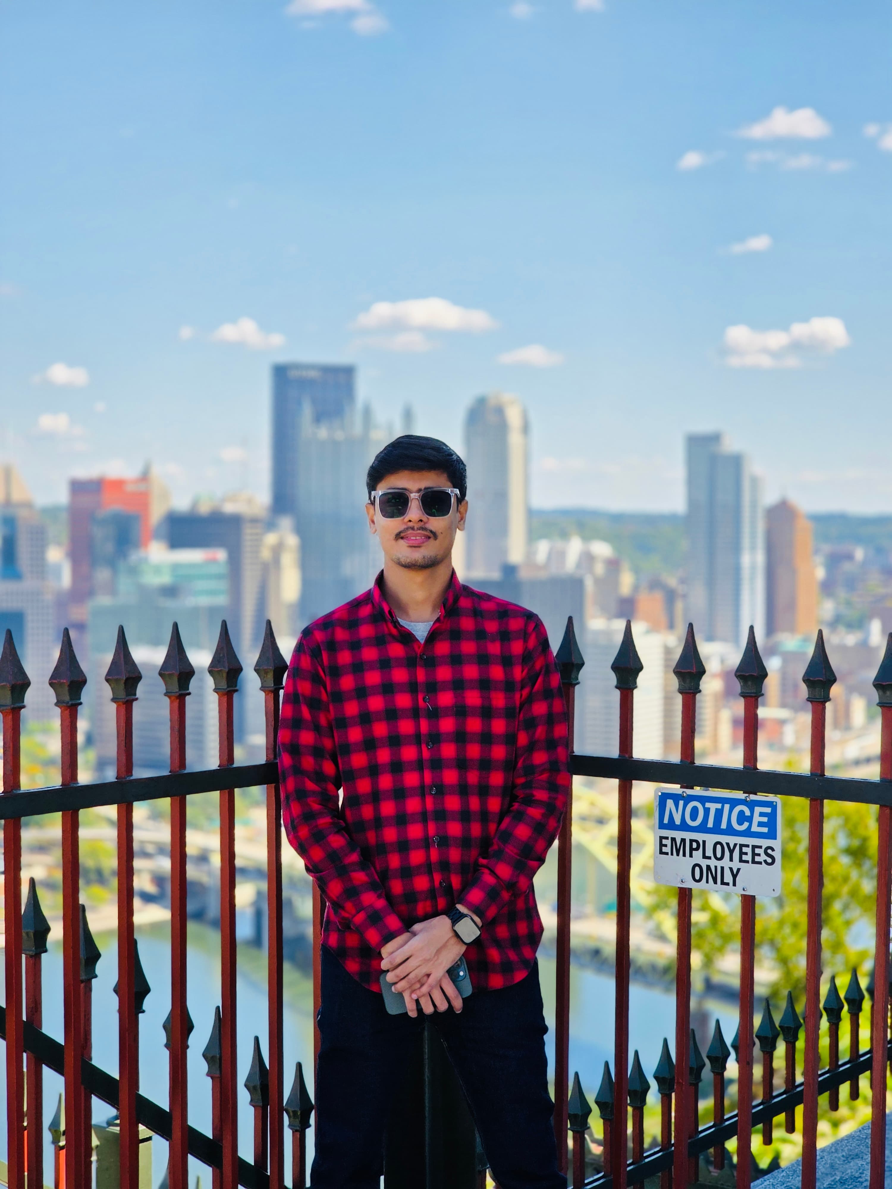 Syed Uzair Ali with the Pittsburgh skyline